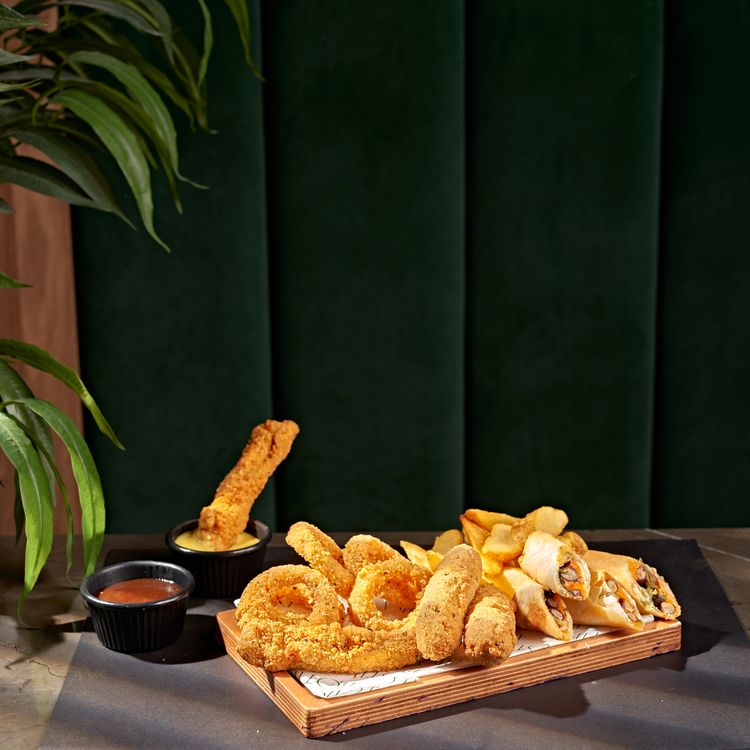 Snack platter with assorted crispy fried finger foods and dips