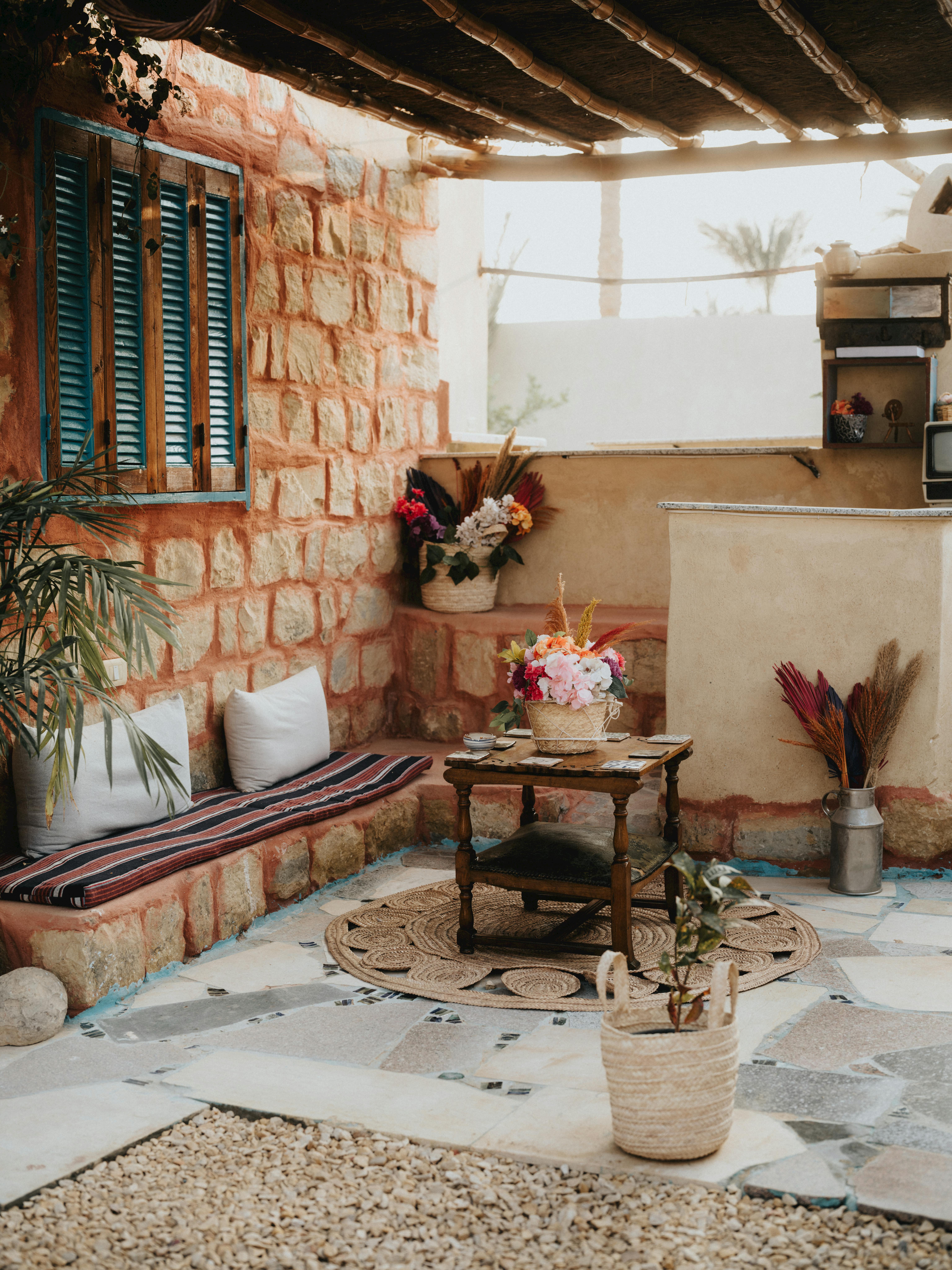Charming outdoor Egyptian patio space with rustic decor and vibrant flowers.