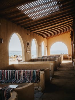 Traditional Egyptian courtyard showcasing arched architecture and vibrant woven textiles, ideal for cultural exploration.