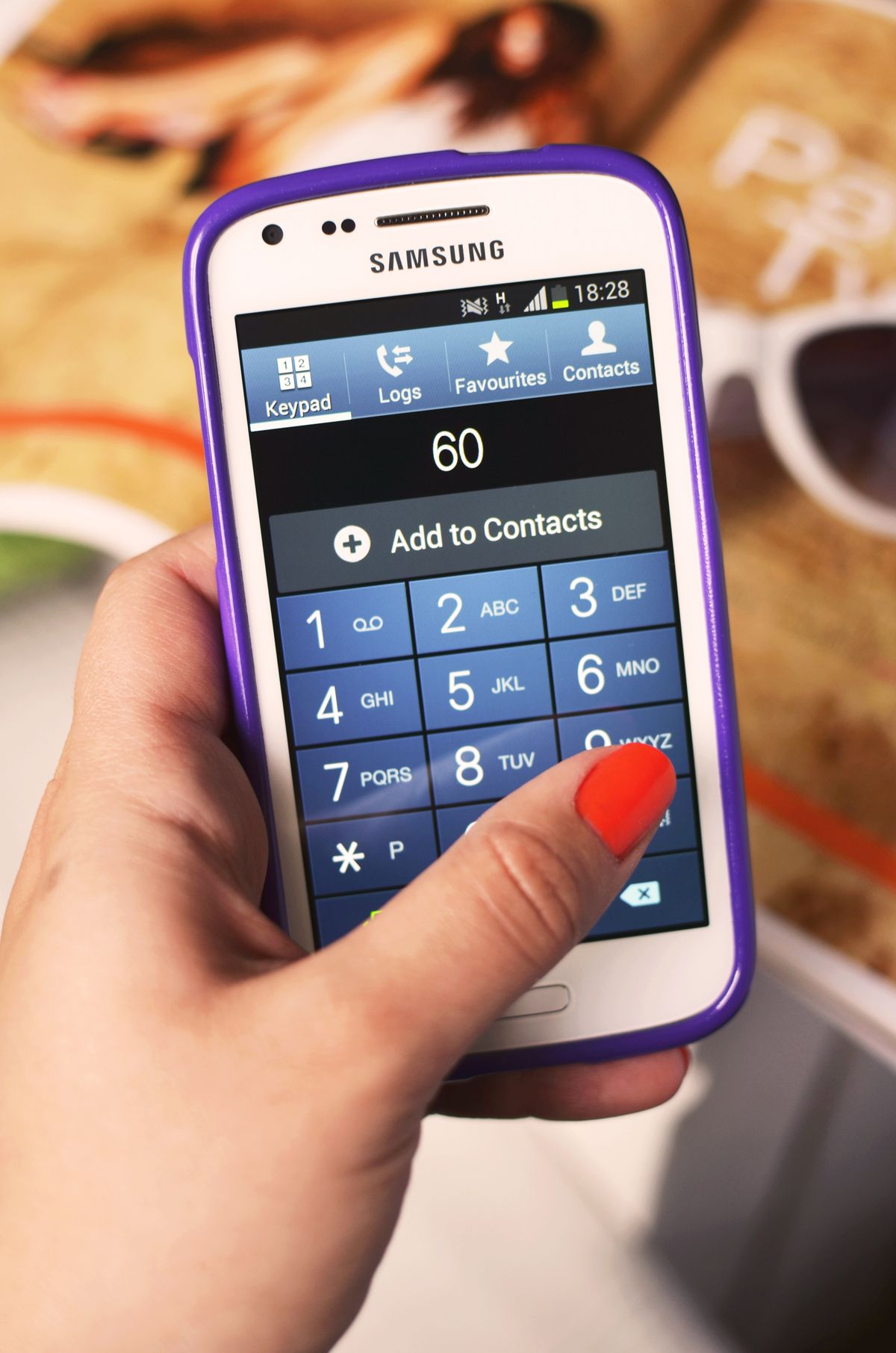 Close-up of a hand dialing on a Samsung smartphone