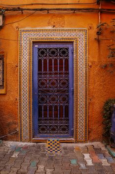 Colorful ornate doorway with intricate tiles in Marrakesh, Morocco.