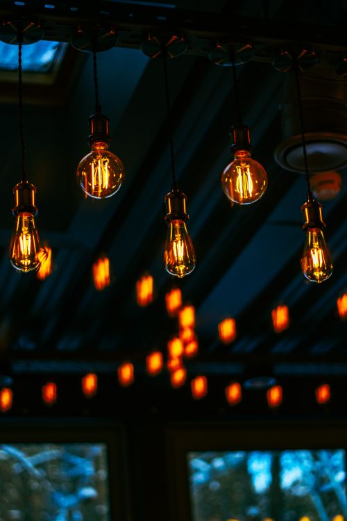 Free Moody overhead view of illuminated vintage Edison bulbs with a soft warm glow. Stock Photo