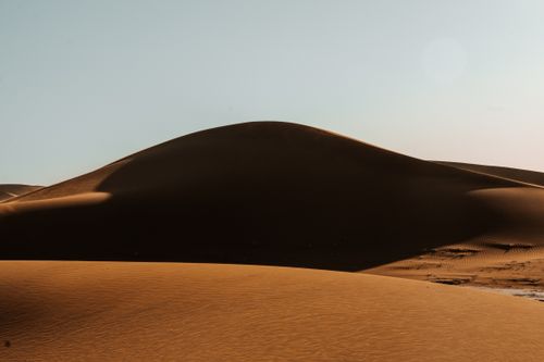 Free Captivating view of sand dunes in Sahara Desert under a clear sky in Morocco. Stock Photo