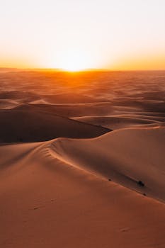 Majestic sunrise over the dunes of the Sahara Desert in Morocco.