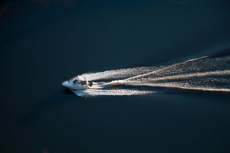 White Speedboat On Body Of Water