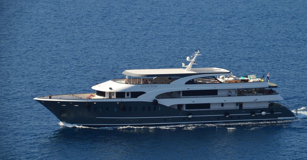 A luxury yacht sailing on calm blue waters under a clear sky, showcasing elegance and adventure.