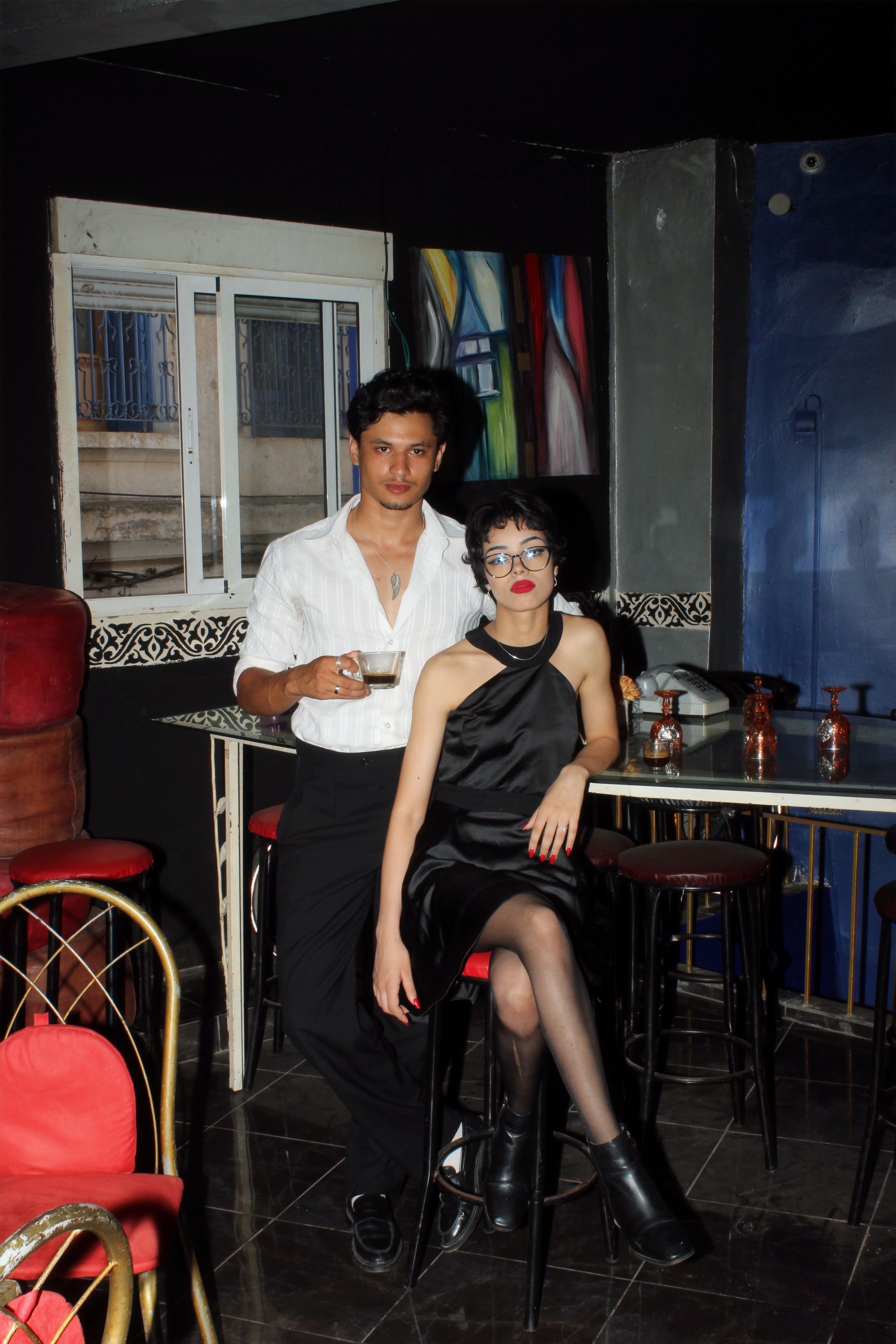 Trendy young adults enjoying a chic night out at a bar in Casablanca, Morocco.