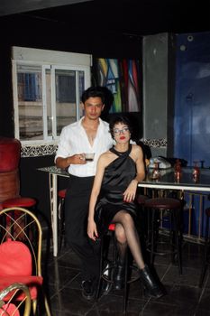 Trendy young adults enjoying a chic night out at a bar in Casablanca, Morocco.