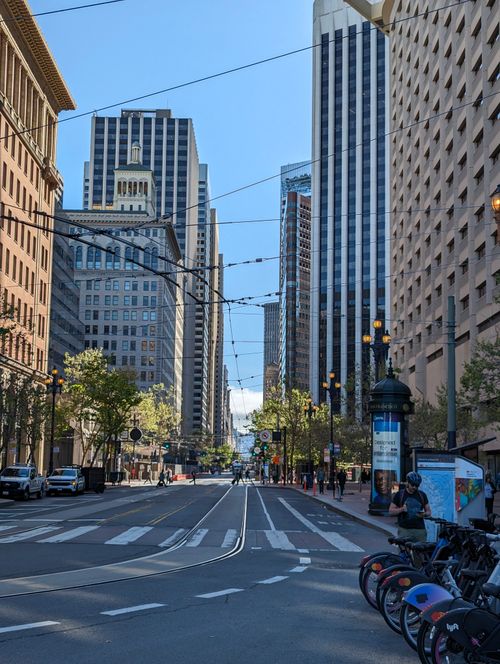 Free Urban cityscape featuring tall skyscrapers, street view, and bicycles in downtown area. Stock Photo