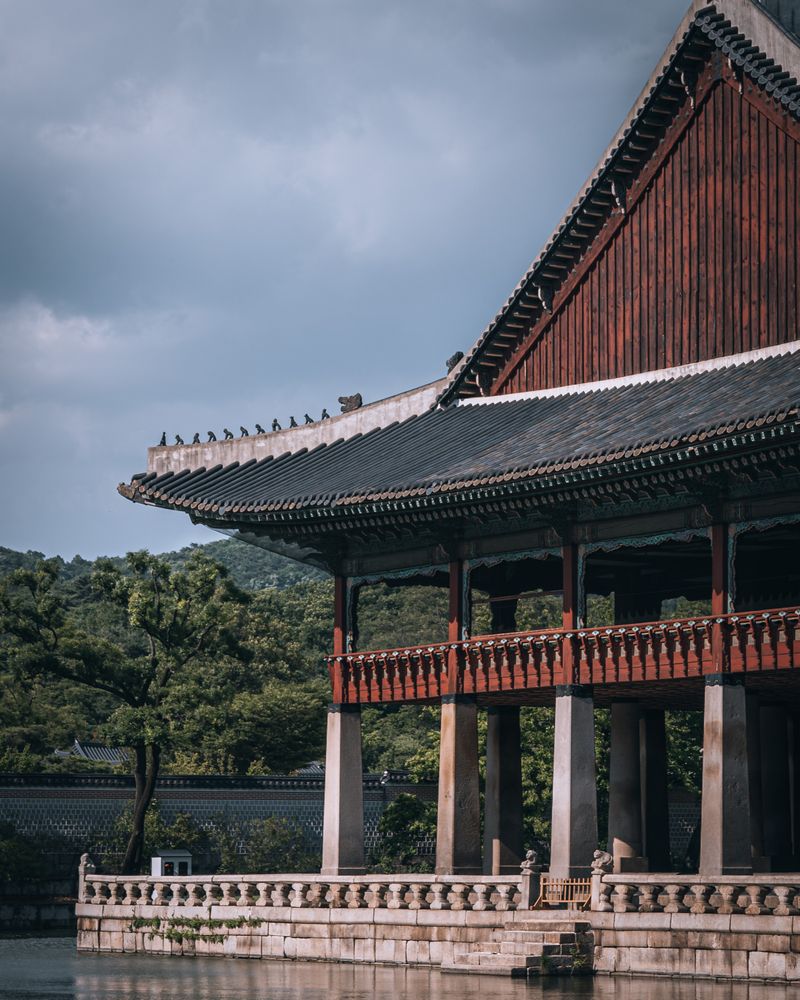 Timber palace pavilion over water in Seoul — photo by Jakob Jin on Pexels