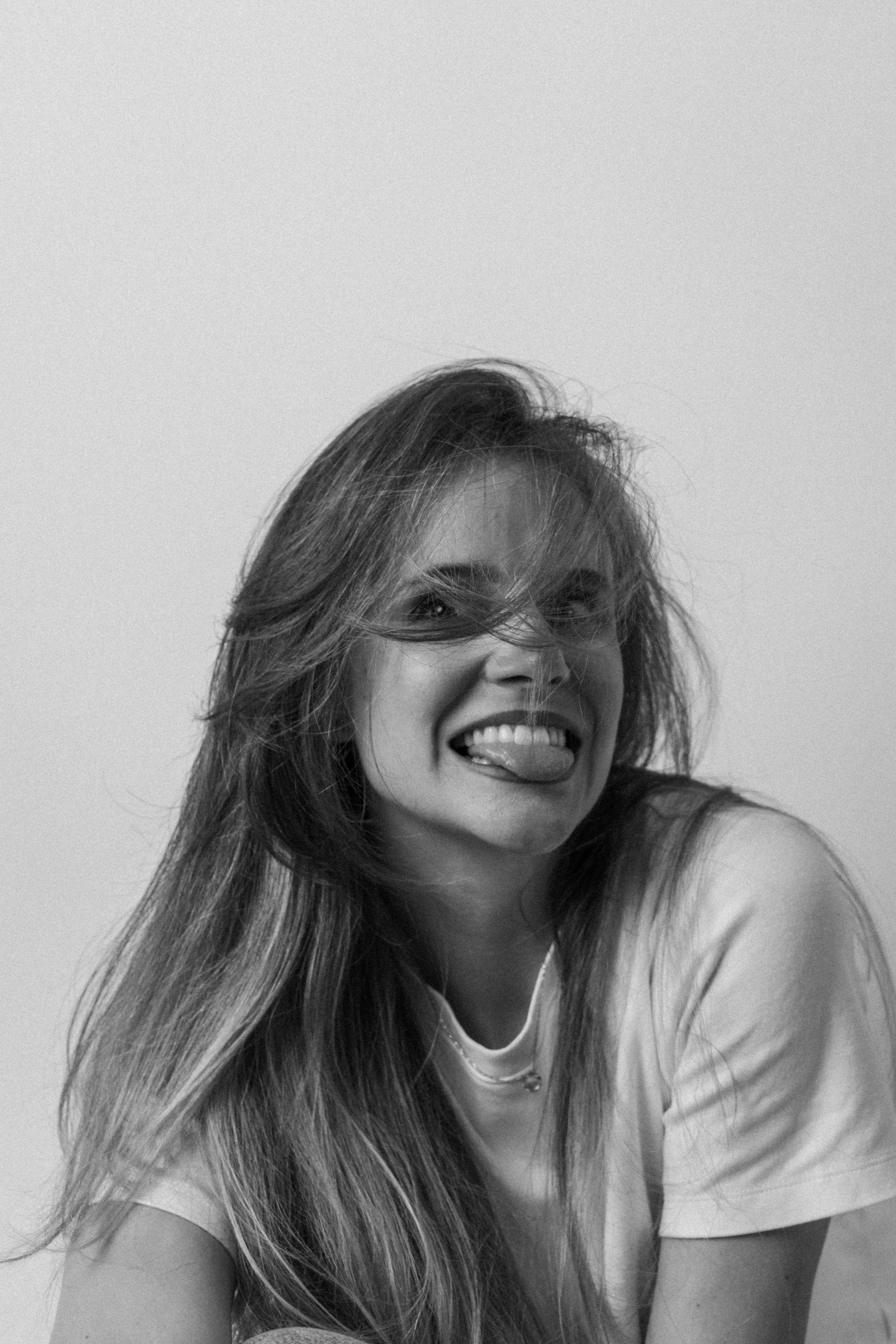 Cheerful Portrait of a Young Woman in Black and White · Free Stock Photo