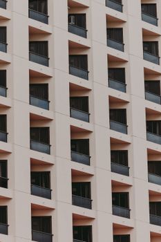 Close-up of a modern apartment building facade in Belém, showcasing geometric windows and balconies.