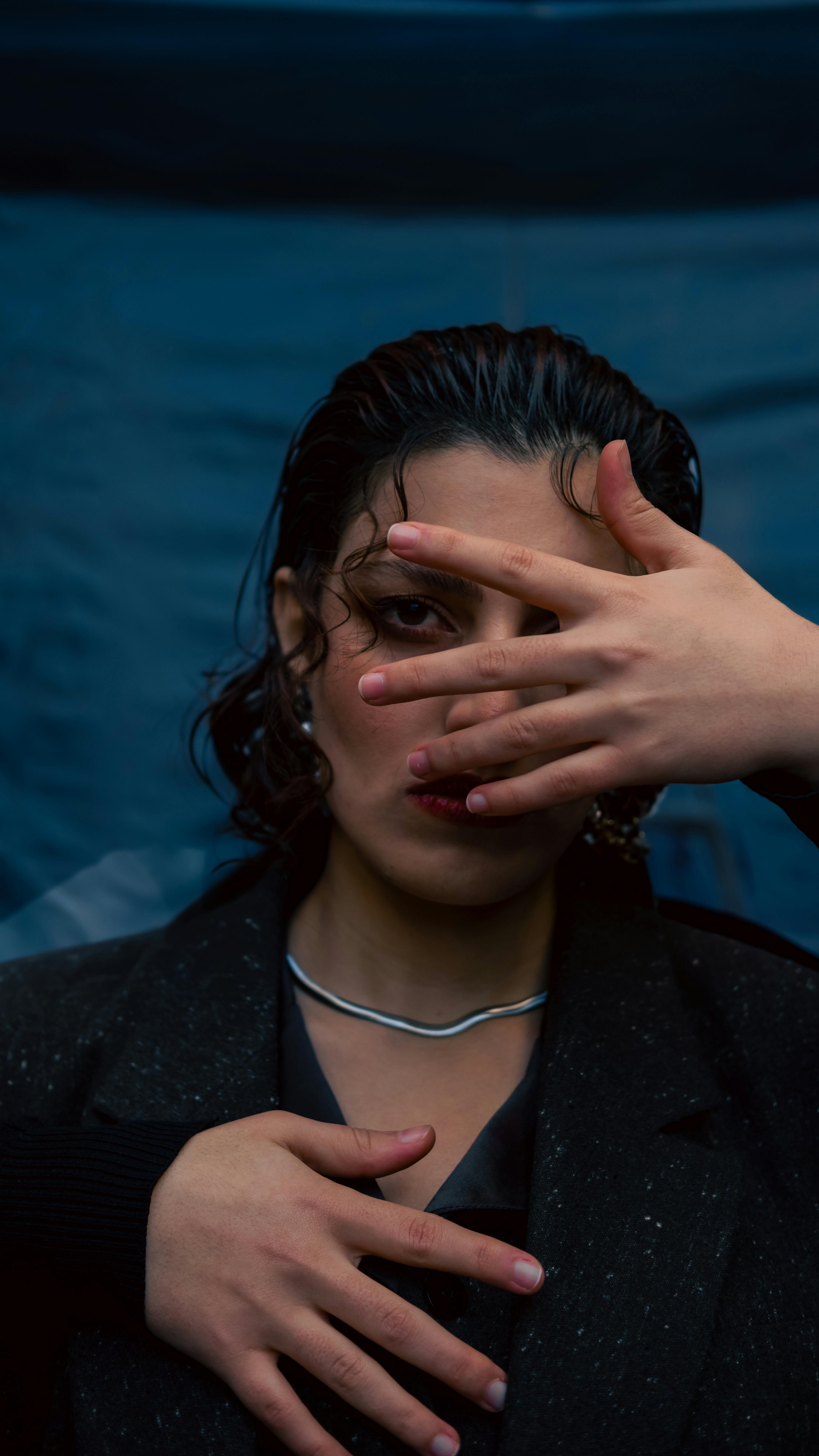 moody portrait of a woman concealing her face