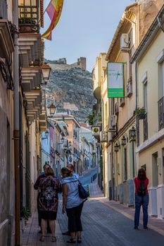 Discover a picturesque street in Jumilla, Spain, with a view of the historic Castillo.