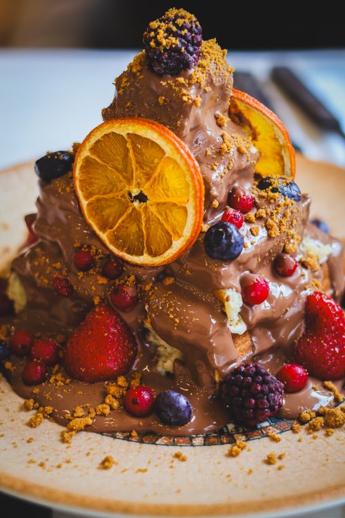 Free Indulge in a rich chocolate dessert adorned with fresh berries, perfect for sweet cravings. Stock Photo