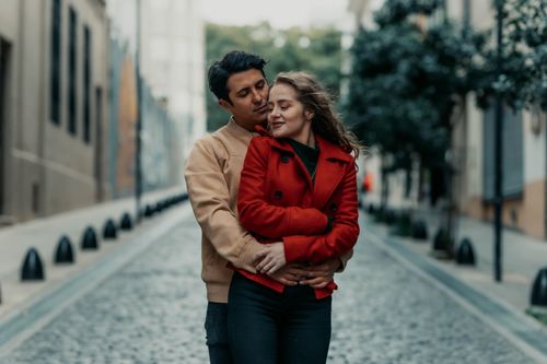 Free A loving couple embraces on a charming street in Buenos Aires, capturing intimacy and urban romance. Stock Photo