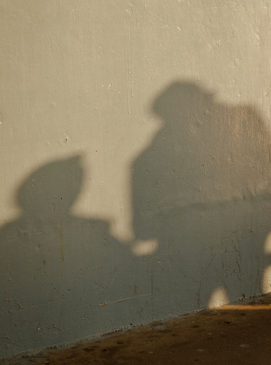 Two Side Shadow Shadow of Two Figures on a Wall · Free Stock Photo