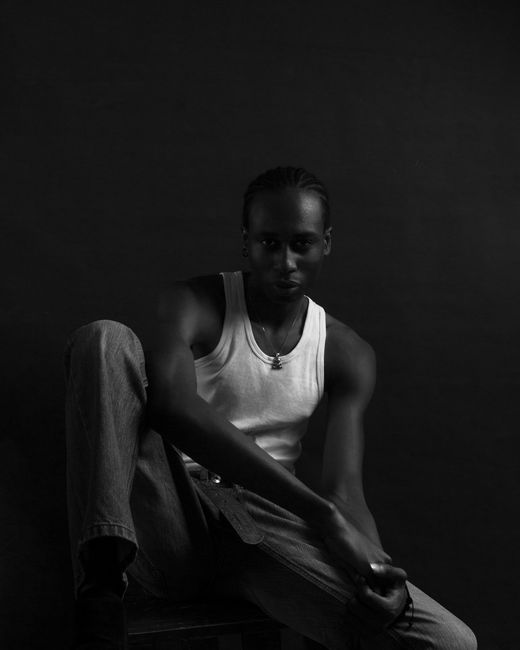 Stylish black and white portrait showcasing a male model from Ibadan, Nigeria.