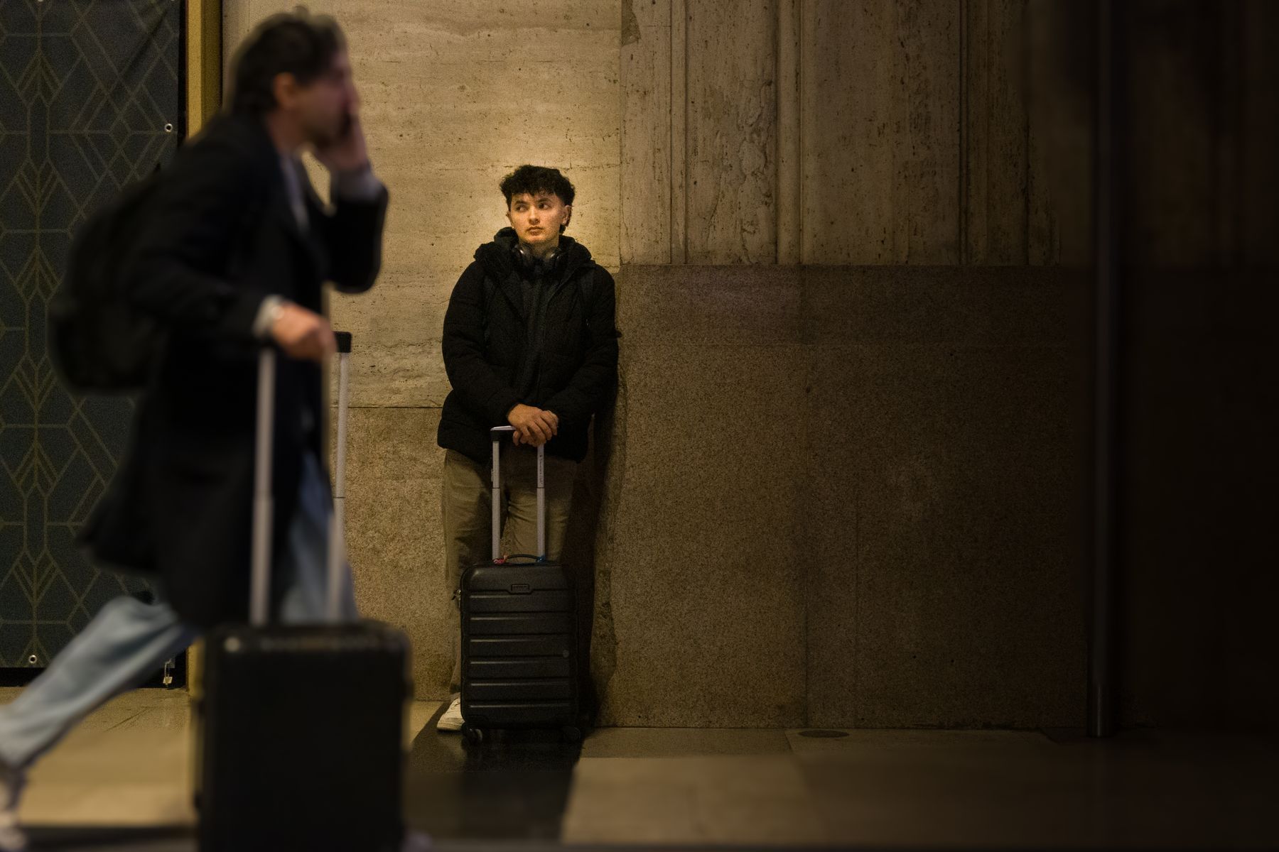 Travelers with luggage moving through a major train station