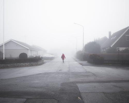 Free Person Walking On Street On A Foggy Day Stock Photo