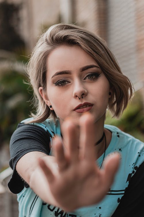 Selective Focus Portrait Photo of Woman Holding Out Her Hand