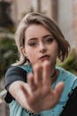 Selective Focus Portrait Photo of Woman Holding Out Her Hand