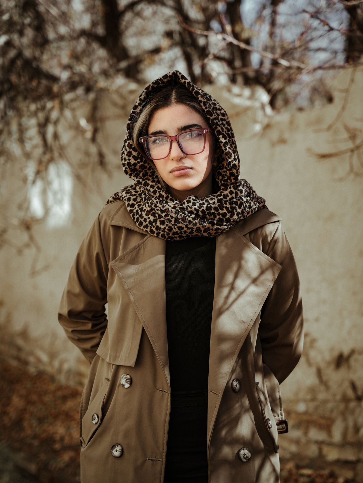 Statement Scarf Outfits for Women — 7 Ways to Style a Scarf as the Star Woman in a leopard-print scarf outdoors