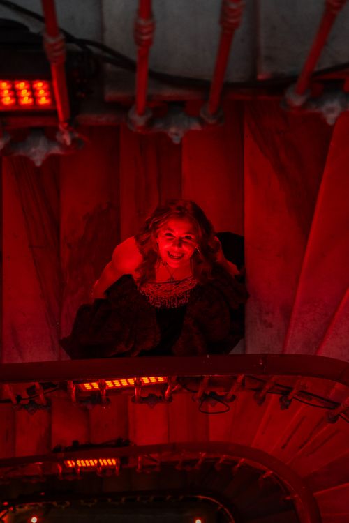 Mysterious Woman on Dimly Lit Spiral Staircase · Free Stock Photo