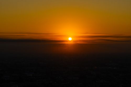 Free Stunning sunset view over Ciudad de México with rich orange hues and silhouetted horizon. Stock Photo
