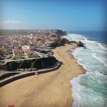 Stunning drone shot of Praia de Santa Cruz beach and town in Portugal's beautiful Atlantic coast.