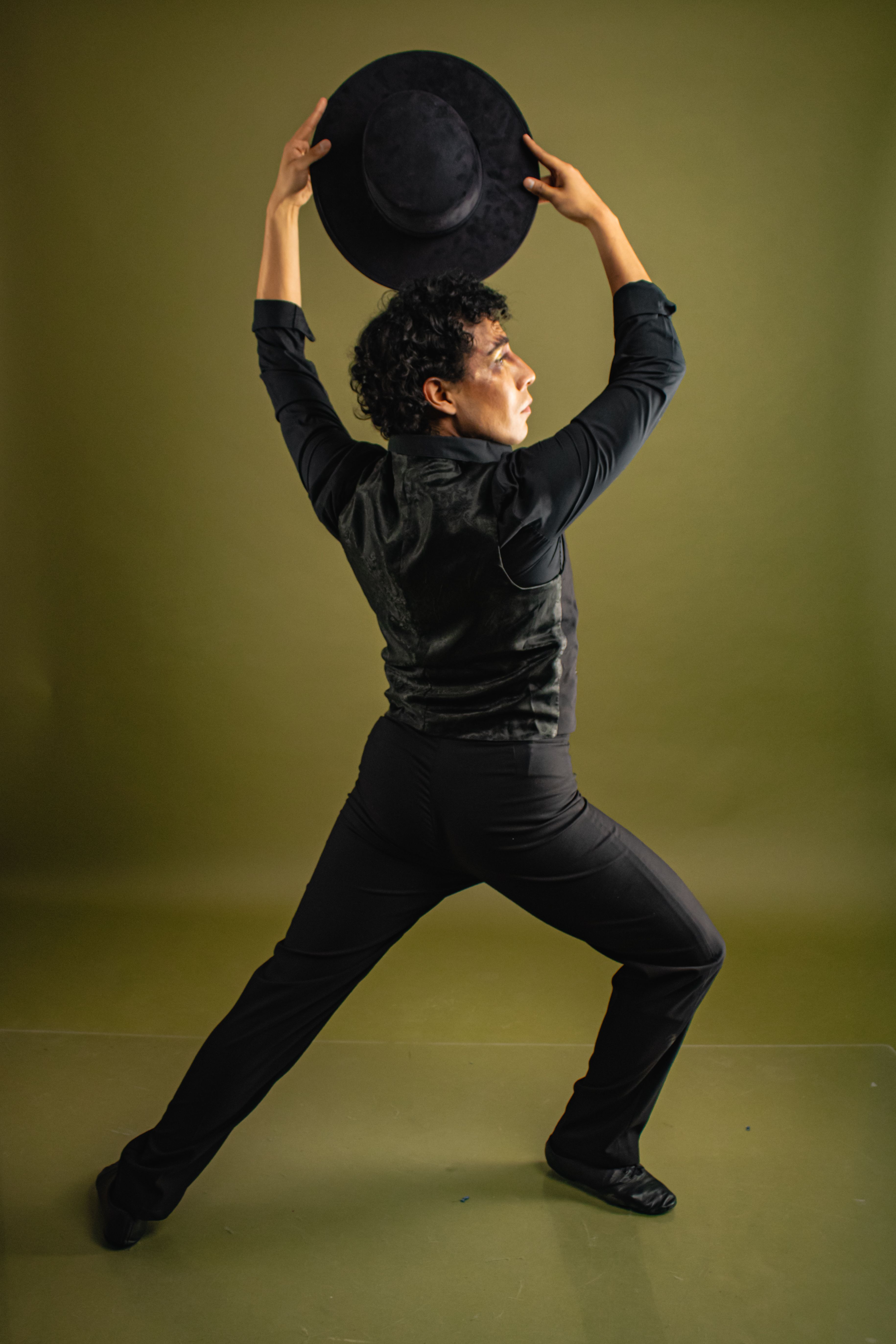 A captivating image of a flamenco dancer striking a pose with a hat.