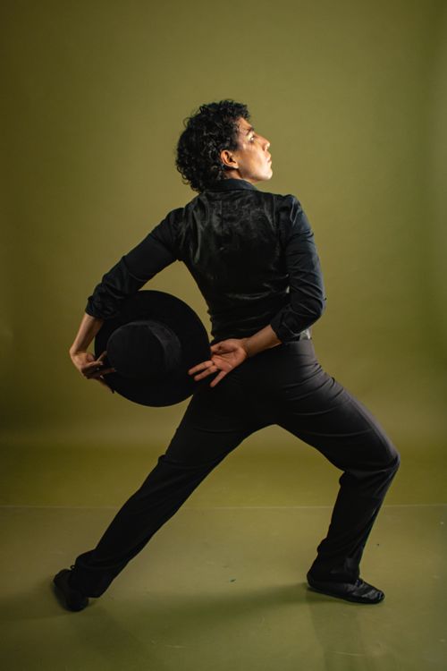 Free Striking pose of a flamenco dancer in black with a traditional hat. Stock Photo