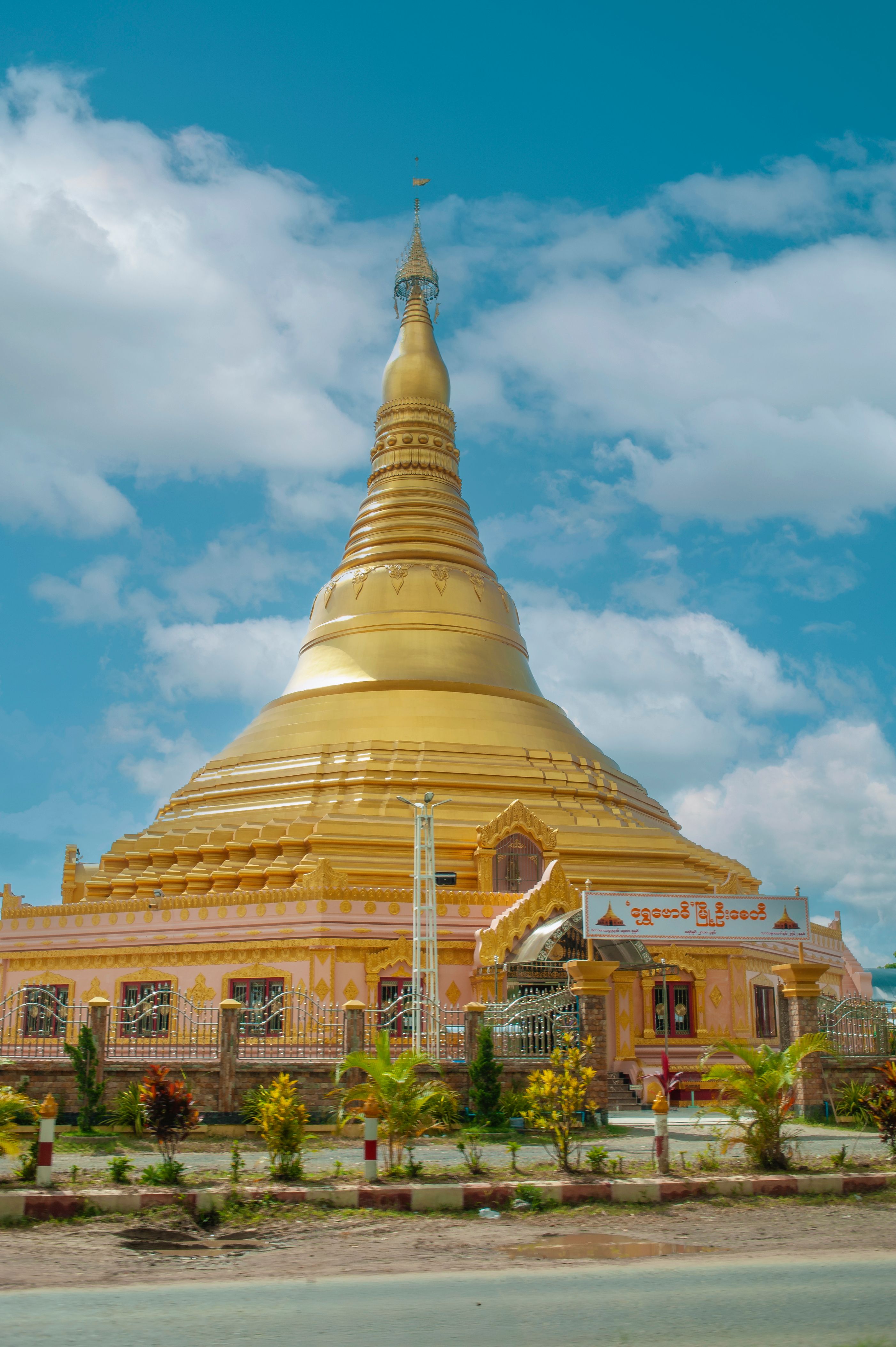 A stunning golden pagoda set under a vibrant blue sky in Nha Trang, Vietnam.