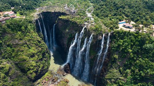 Free A breathtaking aerial shot capturing lush greenery and cascading waterfalls. Stock Photo