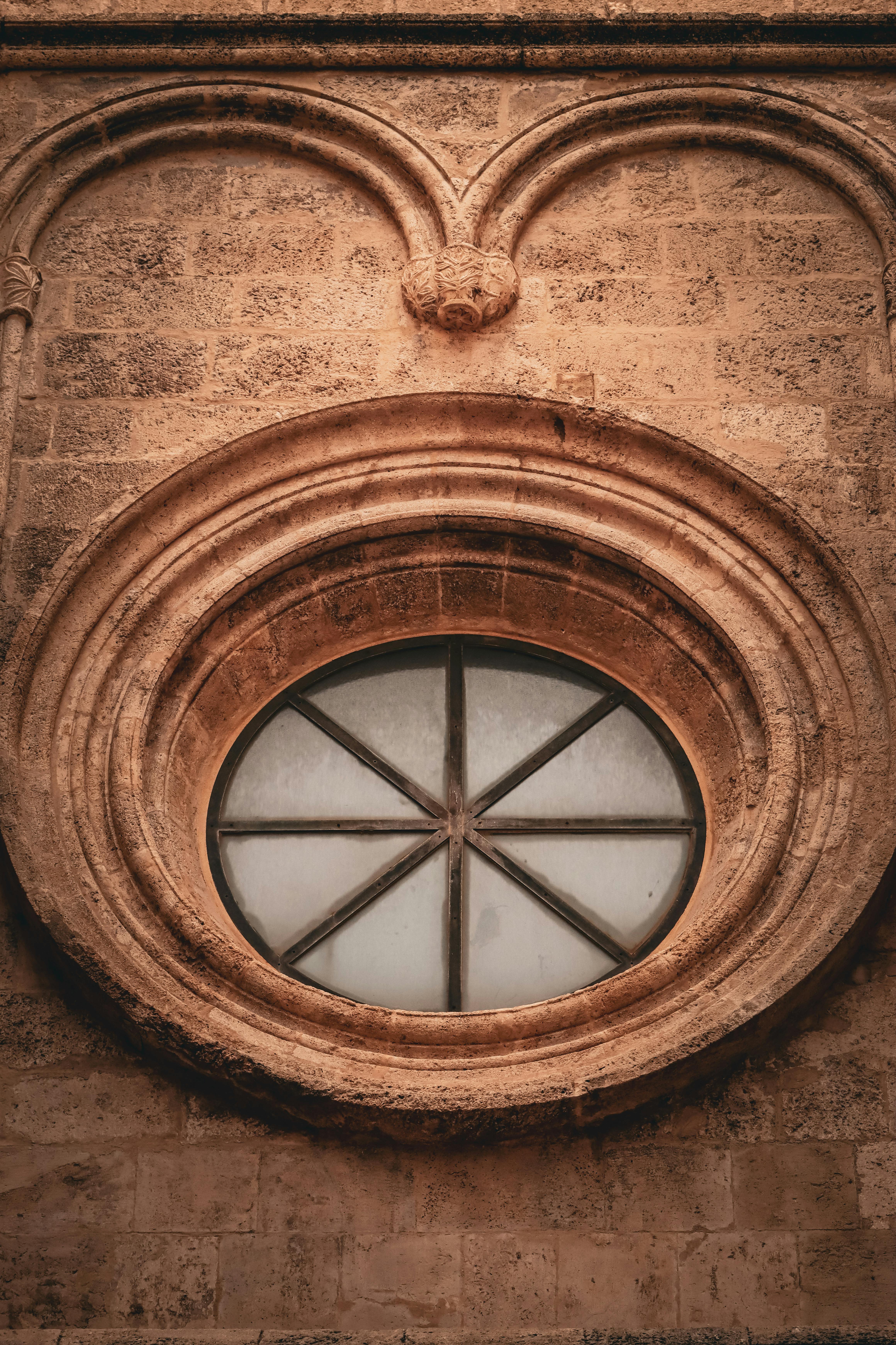 Close-up of an ancient rose window on a historical building in Cagliari, Sardinia.