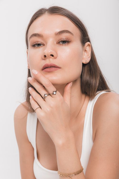 Free Close-up portrait showcasing minimalist jewelry with elegance and style. Stock Photo