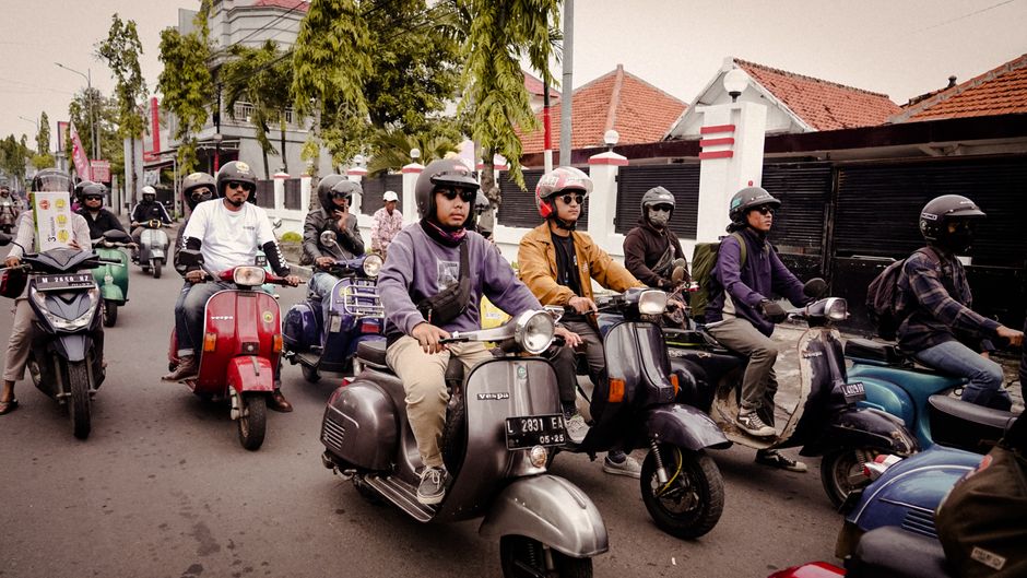 Gojek scooter driver in a busy street in Jakarta, Indonesia
