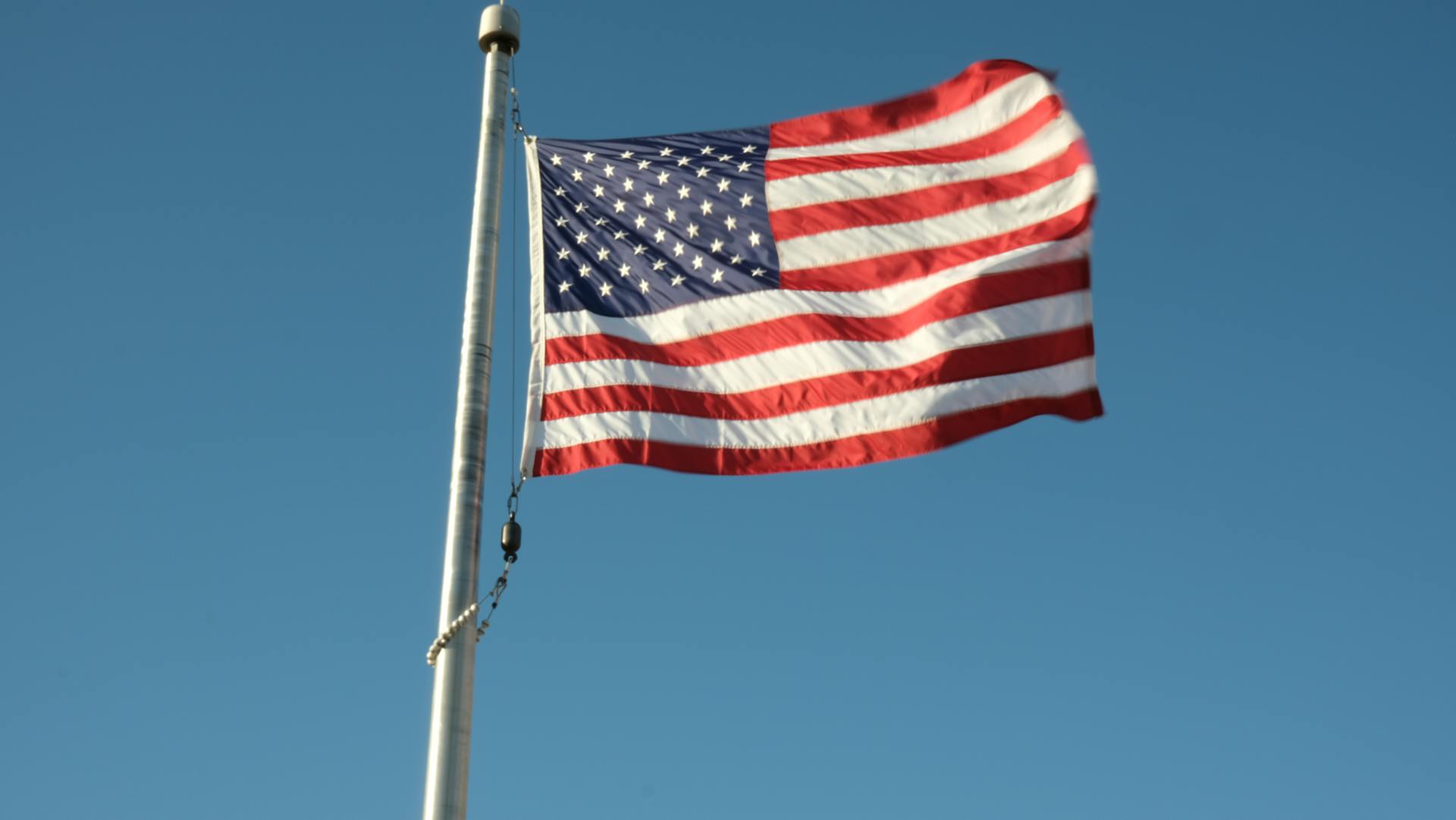 Free stock photo of american flag, blue sky, flag flying