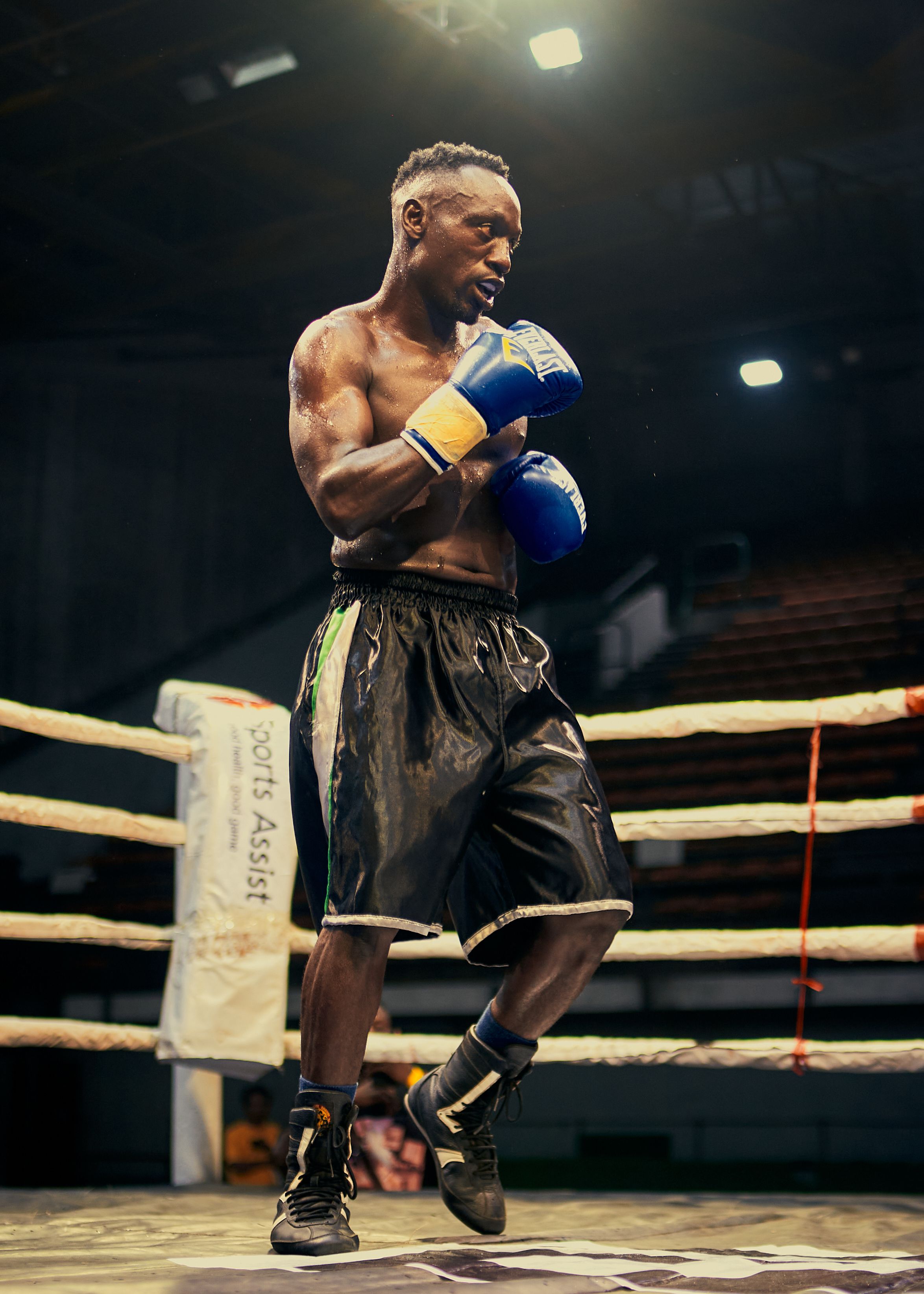 Focused boxer practicing in a Lagos boxing ring. Intense and athletic.