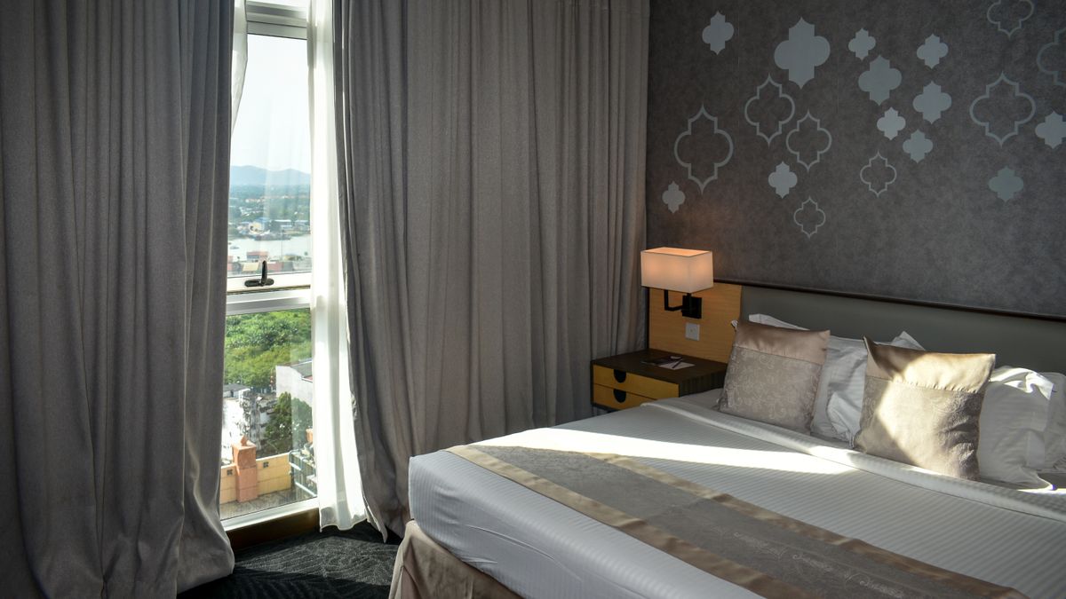 Modern hotel room with a large window and a mountain view