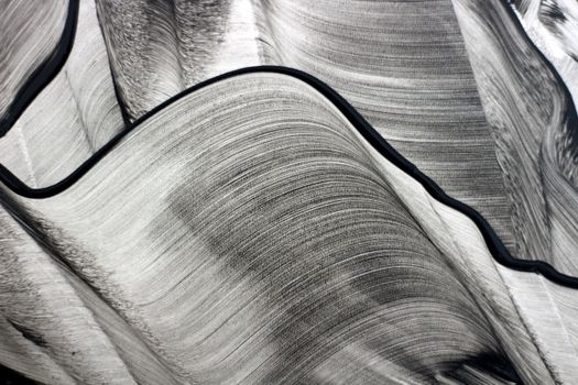 Artistic abstract image of black and white flowing lines, creating a dynamic and textured pattern.