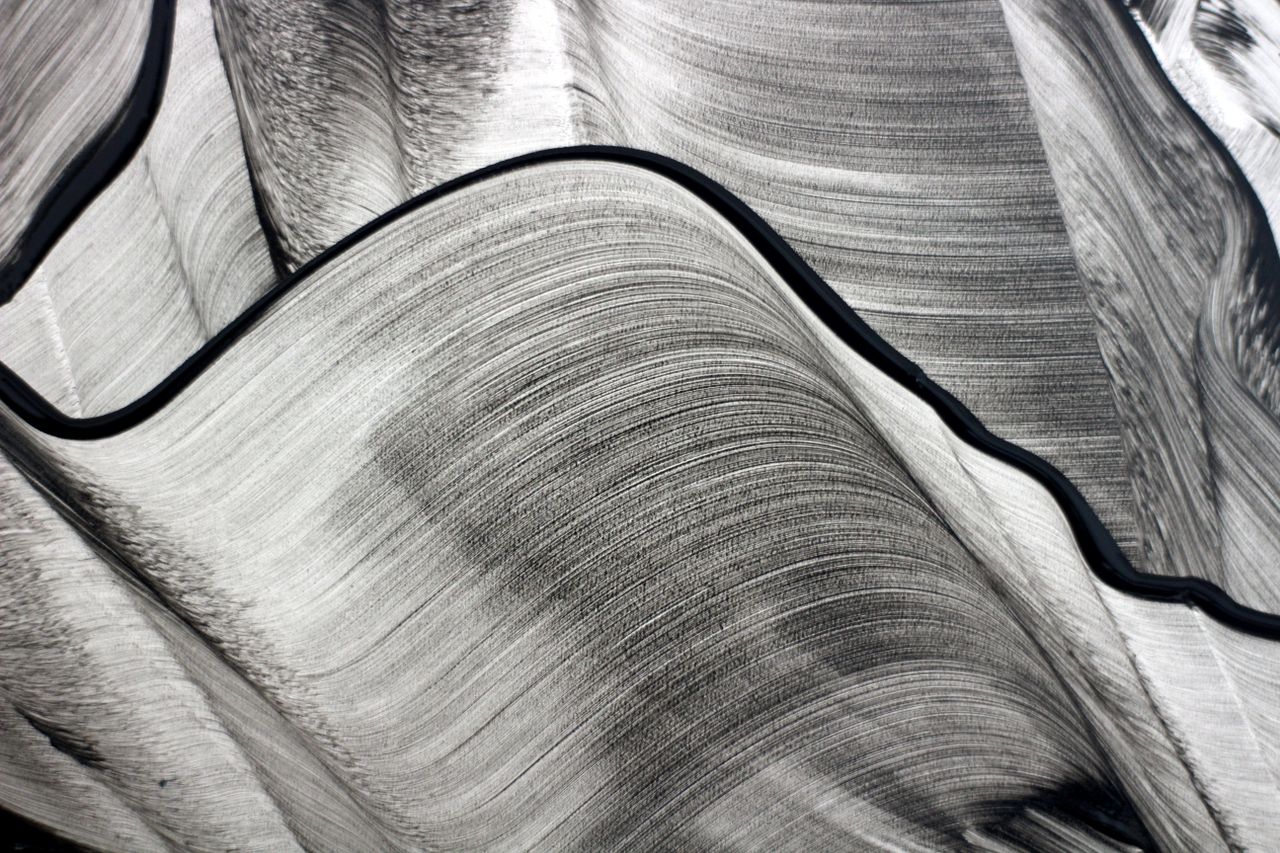 artistic abstract image of black and white flowing lines creating a dy