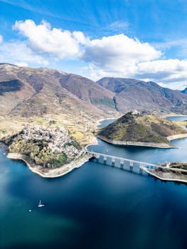 Stunning aerial view of Castel di Tora with blue lakes and mountains in Lazio, Italy.