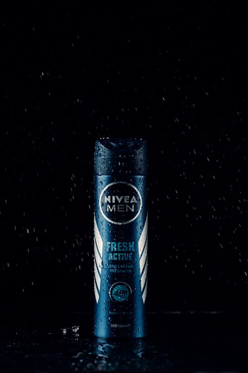 Free Nivea Men Fresh Active Deodorant under ambient lighting with water droplets, enhancing luxury. Stock Photo