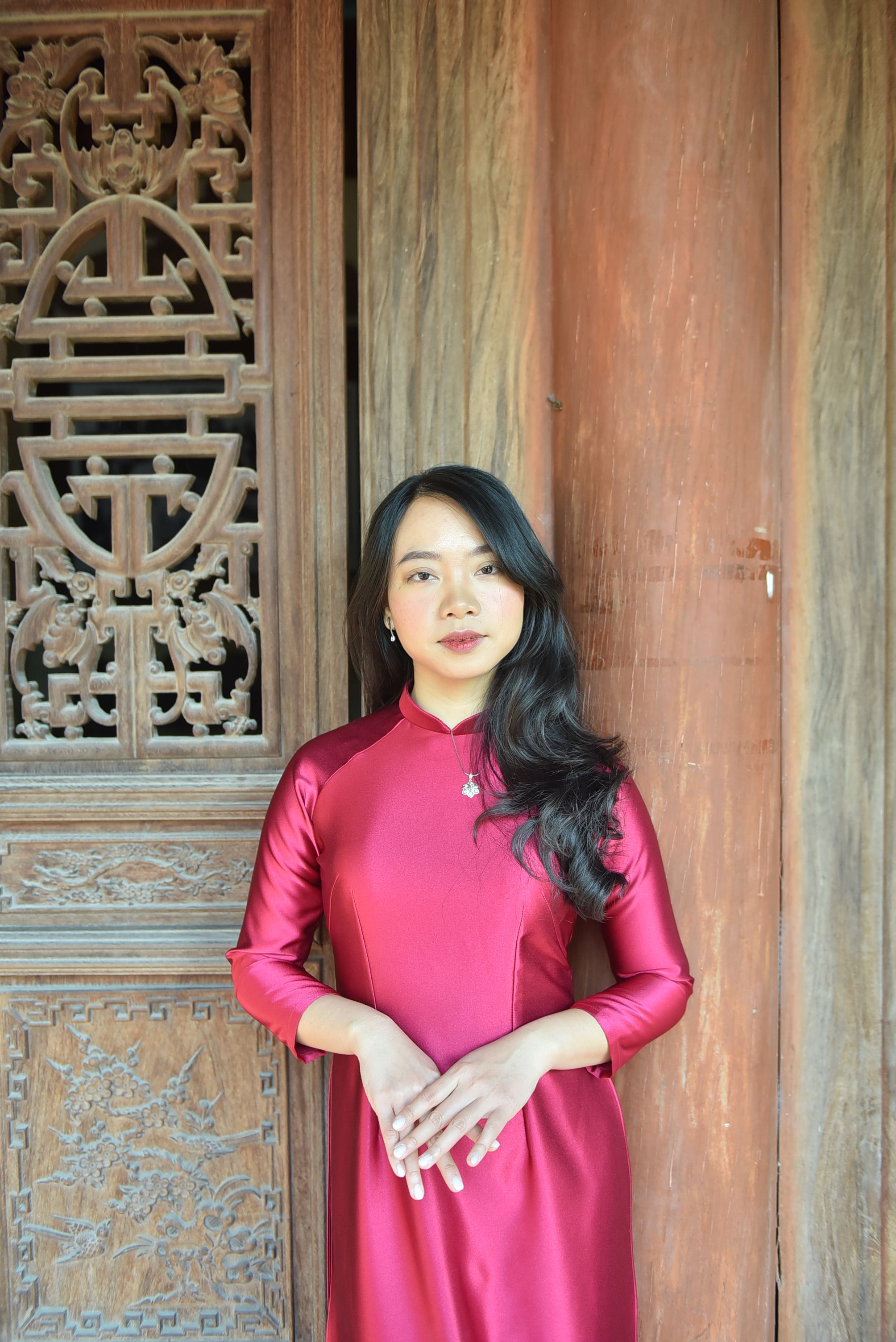 Elegant Woman in Traditional Red Dress at Ornate Doorway · Free Stock Photo