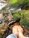 Relaxing Feet in Mossy Stream - Nature Serenity