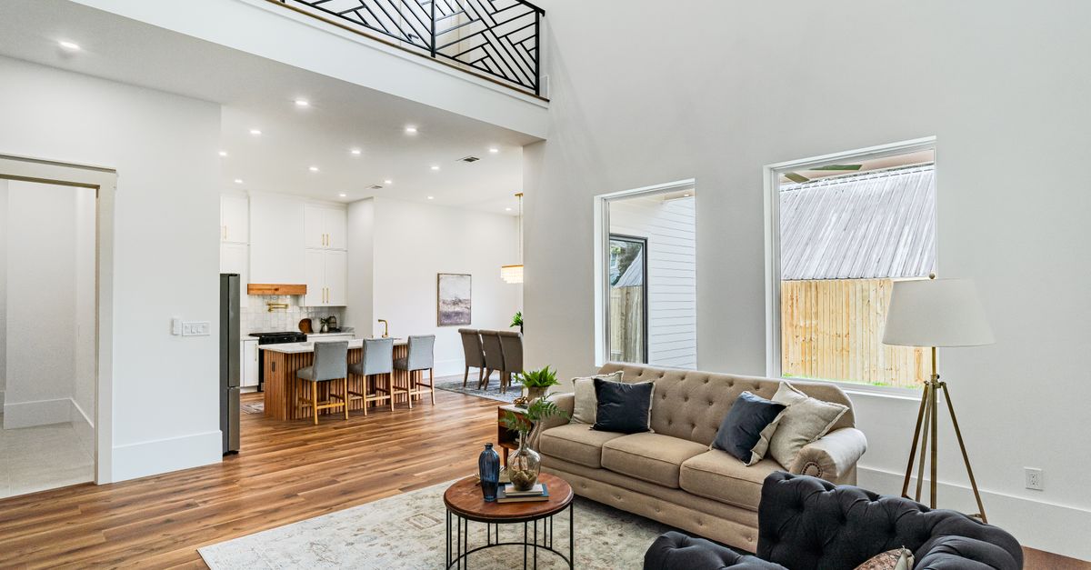 Spacious New Orleans living room with open kitchen and modern decor.