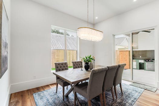 Modern dining area with elegant decor and natural light, perfect for luxury real estate listings.