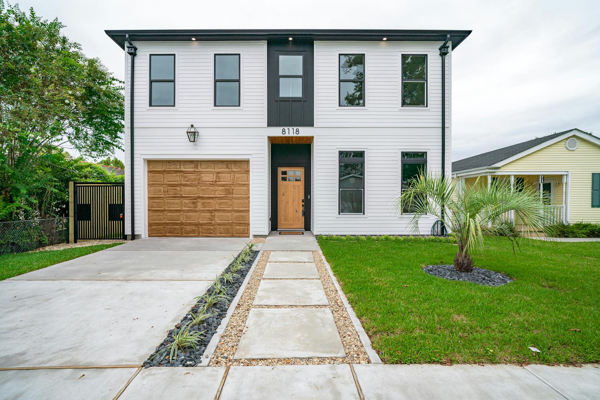 Sleek modern home in New Orleans featuring minimalist architecture and lush landscaping.