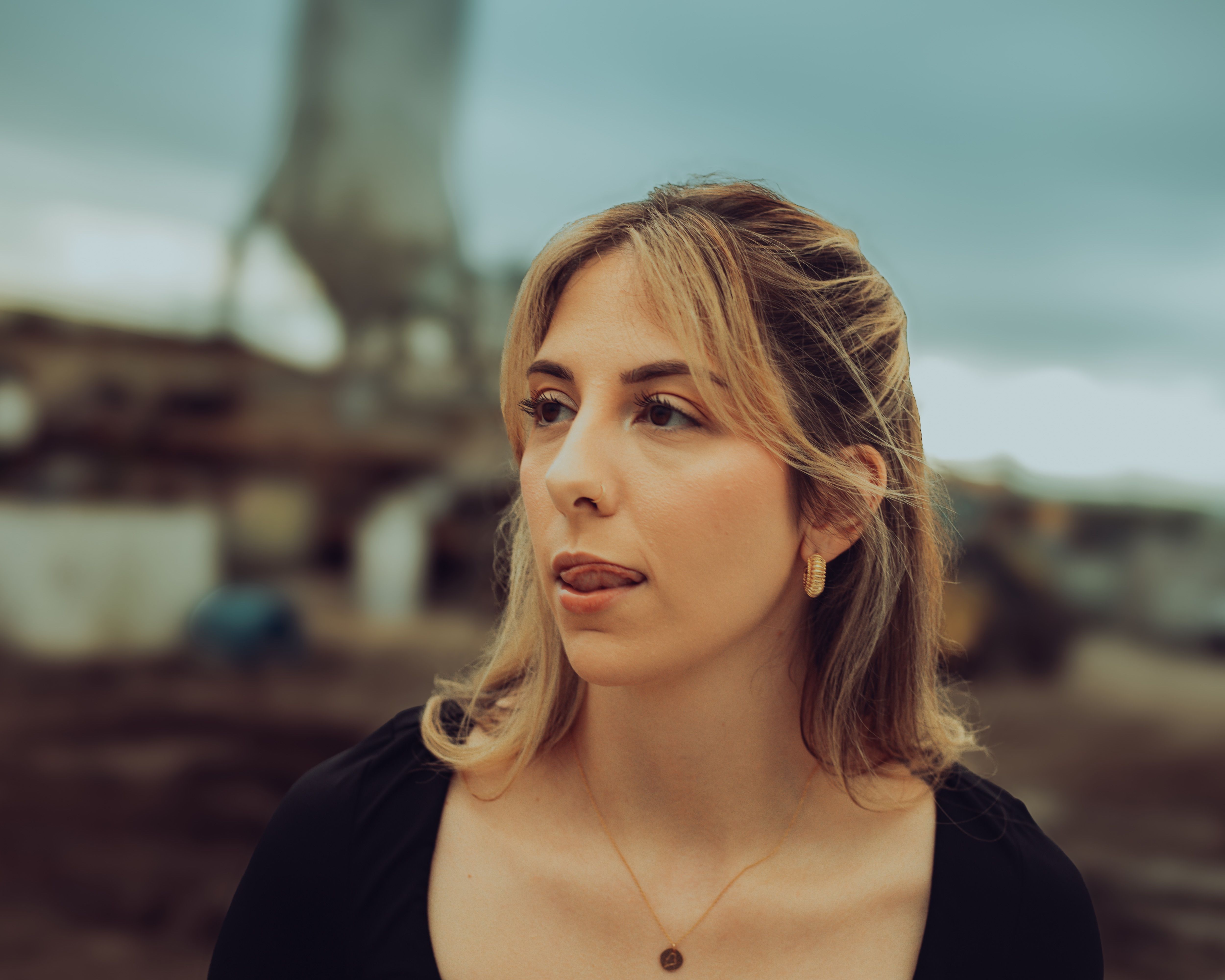 Young Woman Posing Outdoors in Urban Setting · Free Stock Photo